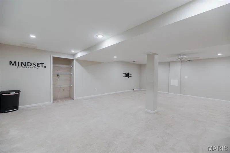 Expansive carpeted room featuring recessed lighting, a built-in wall niche, and a ceiling fan — 1526 Candish Lane, Chesterfield, MO 63017