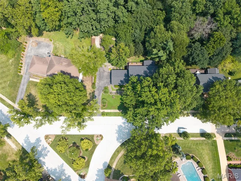 Aerial perspective showcasing a residential property with a multi-gabled roof and an extensive driveway — 1526 Candish Lane, Chesterfield, MO 63017