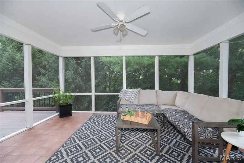 Screened porch featuring a ceiling fan, composite decking, and access to an open-air deck — 1526 Candish Lane, Chesterfield, MO 63017