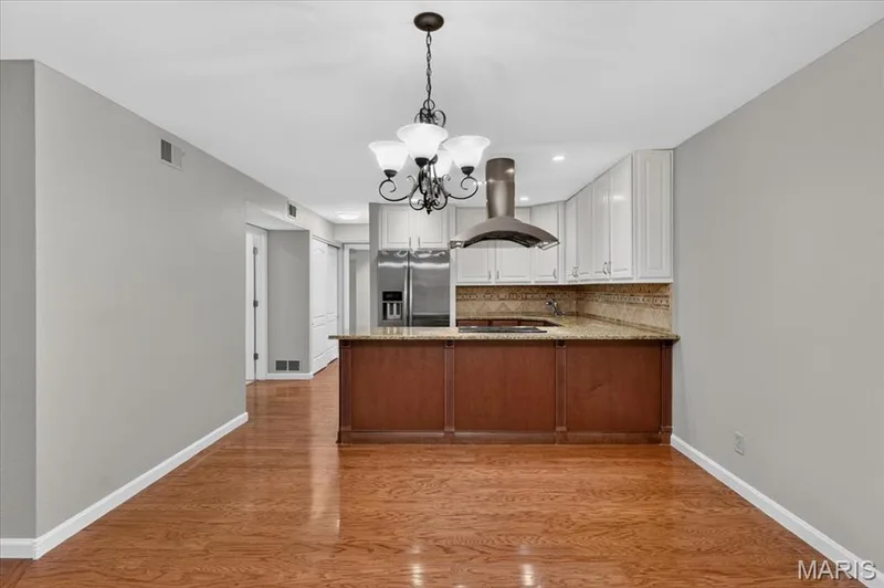 and opens to the kitchen. — 1380 Heritage Landing #202, St Charles, MO 63303