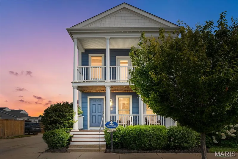 Two-story residence featuring a blue siding exterior with white trim, a gabled roof, and dual-level covered porches with white columns and railings — 3429 Sublette Street, St Charles, MO 63301