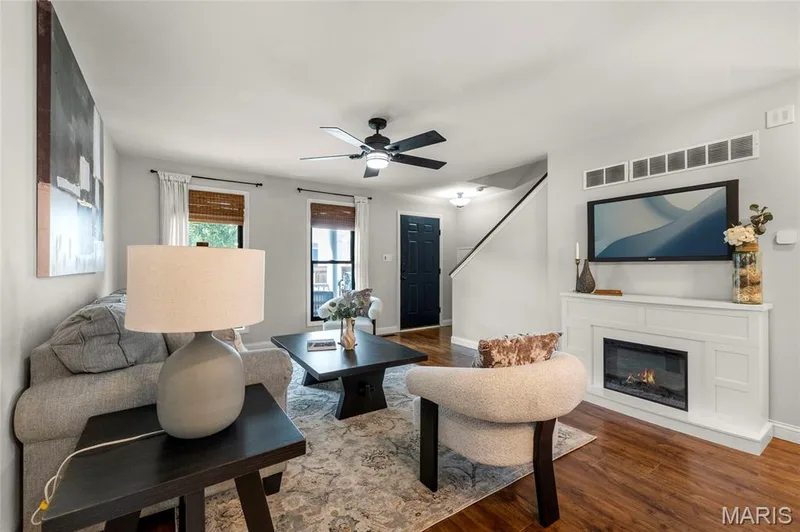 Living area featuring rich wood-finish flooring and light wall colors — 3429 Sublette Street, St Charles, MO 63301