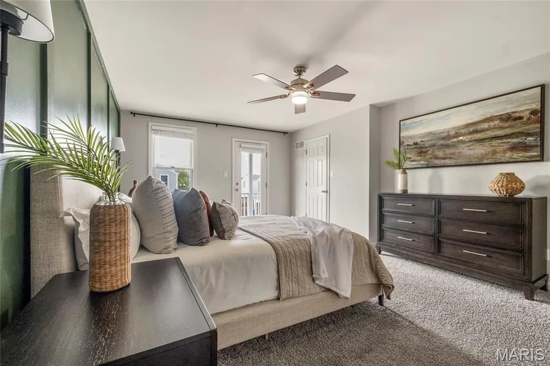 Spacious room featuring textured carpeting, a ceiling fan with integrated lighting, and a board and batten accent wall — 3429 Sublette Street, St Charles, MO 63301