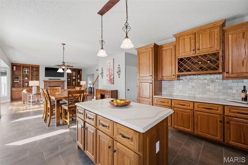 Spacious center island with quartz countertops and open-concept living — 2 Emmons Court #1294, O'Fallon, MO 63368