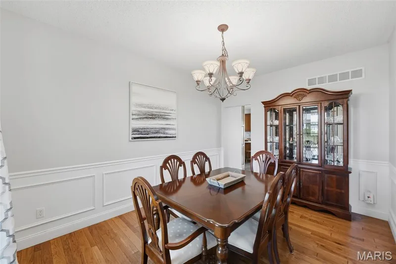 Dining room with wainscoting throughout — 2 Emmons Court #1294, O'Fallon, MO 63368