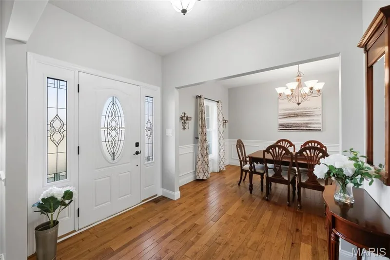 Entryway with hardwood flooring and decorative front door with sidelights — 2 Emmons Court #1294, O'Fallon, MO 63368