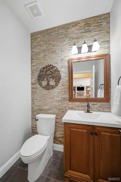 Main floor half bath with stone accent wall — 2 Emmons Court #1294, O'Fallon, MO 63368