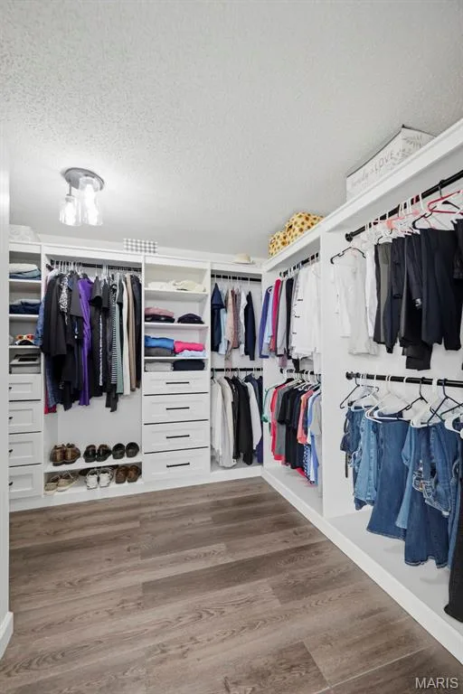 Spacious walk-in closet with custom built-in shelving and storage. — 2 Emmons Court #1294, O'Fallon, MO 63368