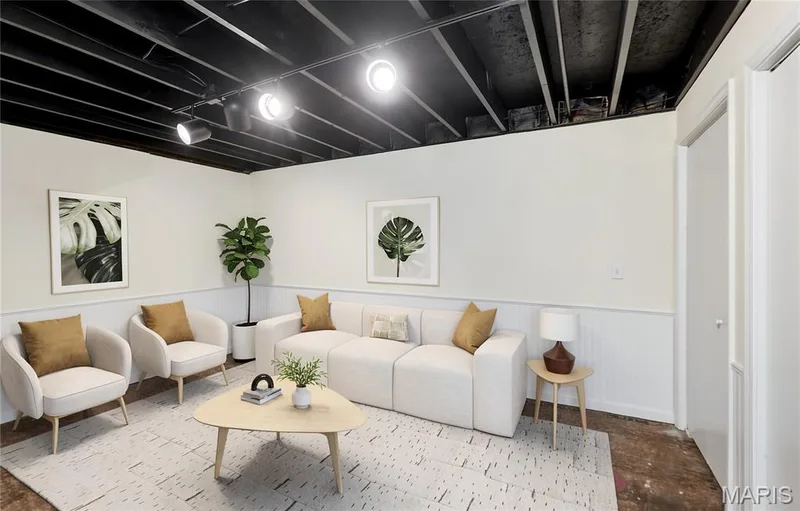 Lower level family room with exposed ceiling beams with track lighting and wainscoting — 146 Old Buggy Court #A, St Charles, MO 63304