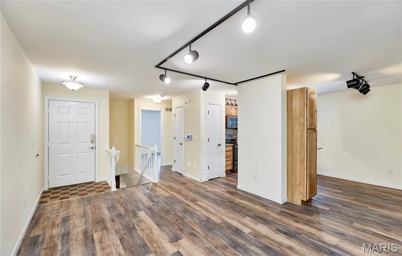 Wood-finish flooring throughout, track lighting, light wood cabinetry — 146 Old Buggy Court #A, St Charles, MO 63304