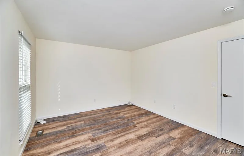 Wood-finish flooring, white walls, two windows with blinds — 146 Old Buggy Court #A, St Charles, MO 63304