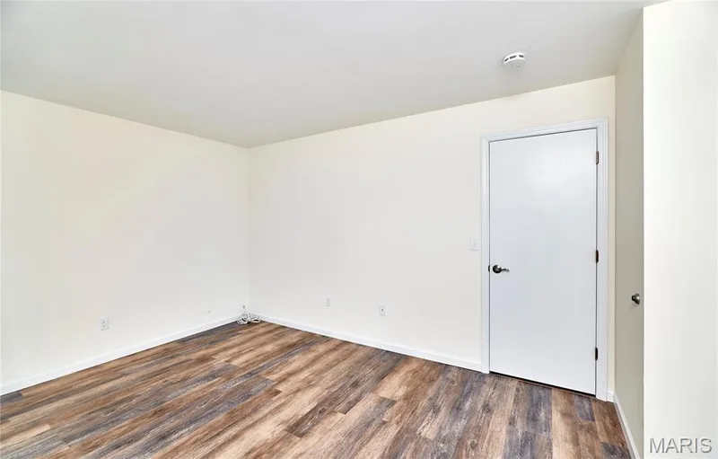 Wood-finish flooring, white walls, two windows with blinds — 146 Old Buggy Court #A, St Charles, MO 63304