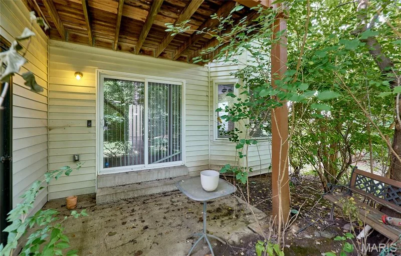 Covered concrete patio space, sliding glass door — 146 Old Buggy Court #A, St Charles, MO 63304