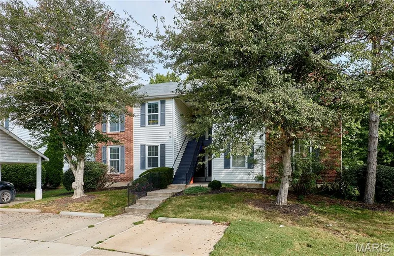 Brick and siding exterior with mature trees — 146 Old Buggy Court #A, St Charles, MO 63304