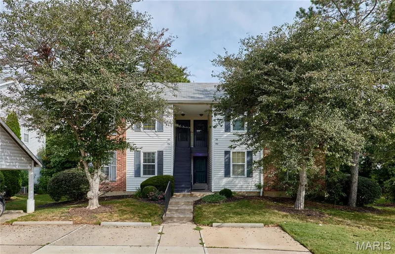 Two-story residential building with white siding and blue shutters — 146 Old Buggy Court #A, St Charles, MO 63304
