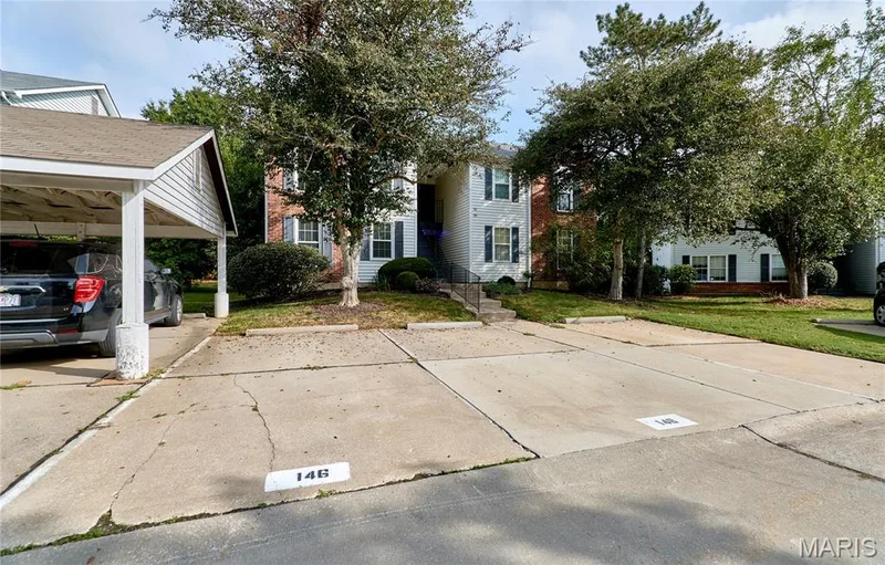Brick and siding exterior with mature landscaping — 146 Old Buggy Court #A, St Charles, MO 63304