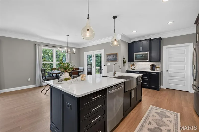 Kitchen Island with Quartz Countertops and Seating Bar — 517 Stonewolf Creek Drive, Wentzville, MO 63385