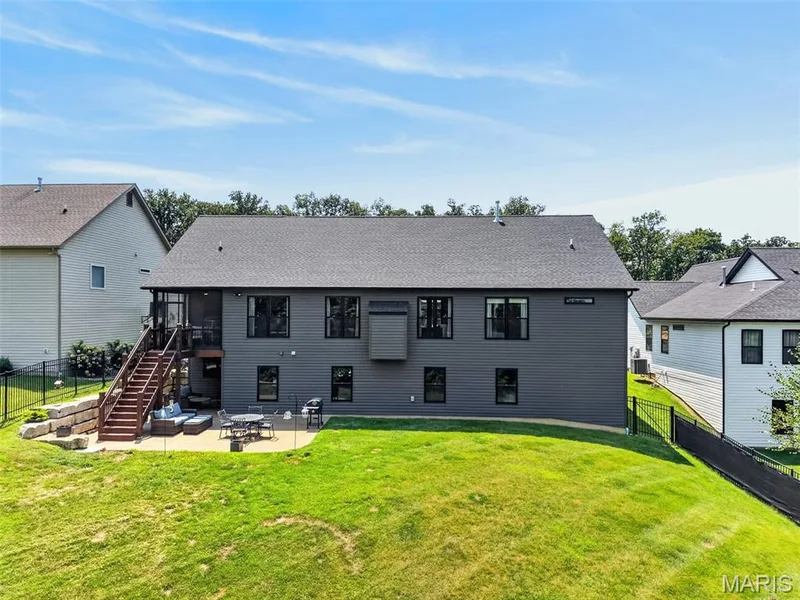 Back of Home with Fenced Yard, Screened Deck and Covered and Open Patio — 517 Stonewolf Creek Drive, Wentzville, MO 63385