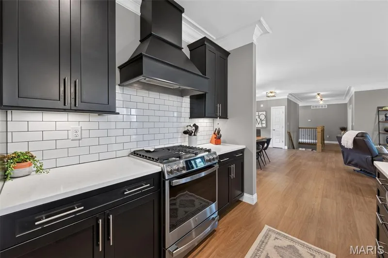 Kitchen with Quartz Countertops, Gas Range and Chimney Style Range Hood — 517 Stonewolf Creek Drive, Wentzville, MO 63385