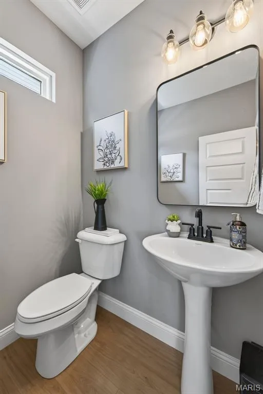 Powder Room with Luxury Vinyl Plank Flooring and Transom Window — 517 Stonewolf Creek Drive, Wentzville, MO 63385