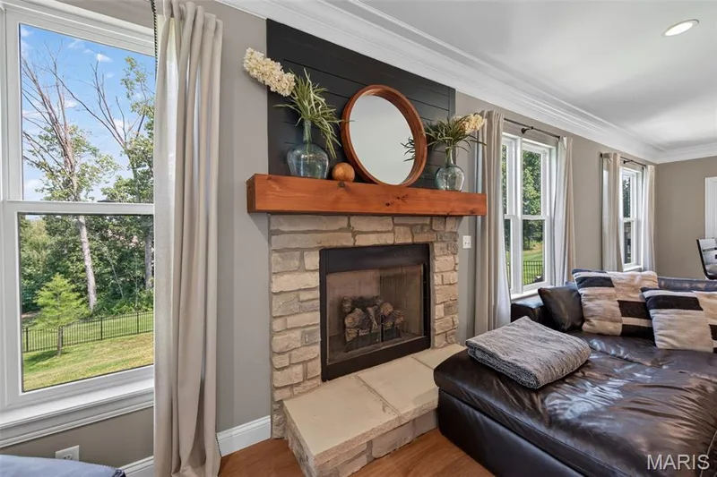 Gas Fireplace with Stone Surround, Rustic Mantle and Stone Hearth — 517 Stonewolf Creek Drive, Wentzville, MO 63385
