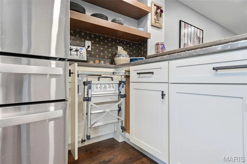 It's not hard to reach those top shelves with a step ladder conveniently tucked into the cabinet. — 13473 Coliseum Drive, Chesterfield, MO 63017