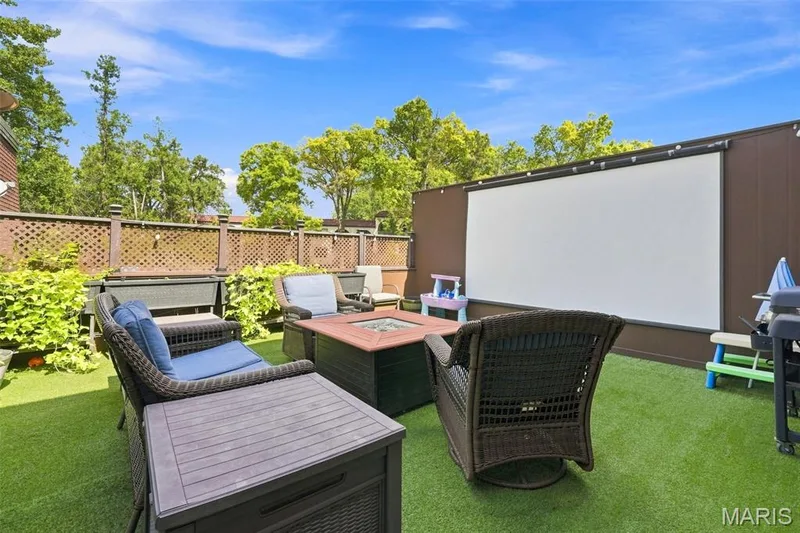 Another special feature. It's a comfortable deck great for meals, coffee or just relaxing by day. At night it turns into an outside cinema. Invite friends over for a movie night — 13473 Coliseum Drive, Chesterfield, MO 63017