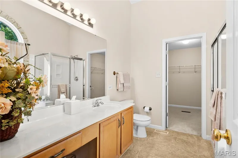 Primary bath looking into walk-in closet — 8 Autumn Grove Court, O'Fallon, MO 63366