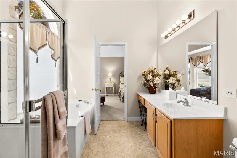 Primary bath displaying separate tub and shower, vanity with maple cabinets — 8 Autumn Grove Court, O'Fallon, MO 63366
