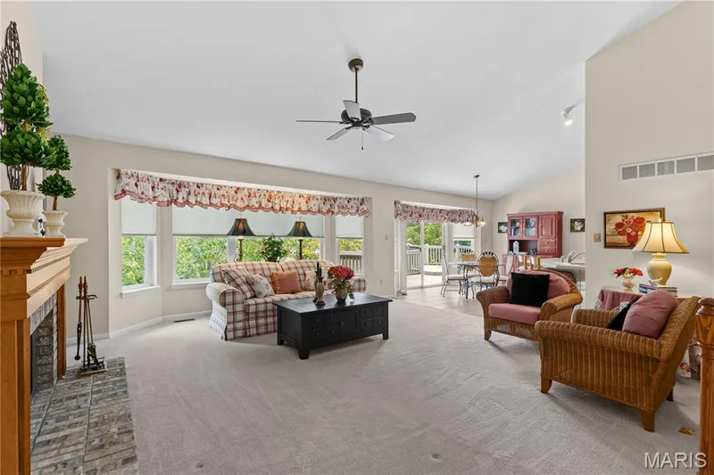 View of spacious great room from foyer showing bay window, vaulted ceiling — 8 Autumn Grove Court, O'Fallon, MO 63366