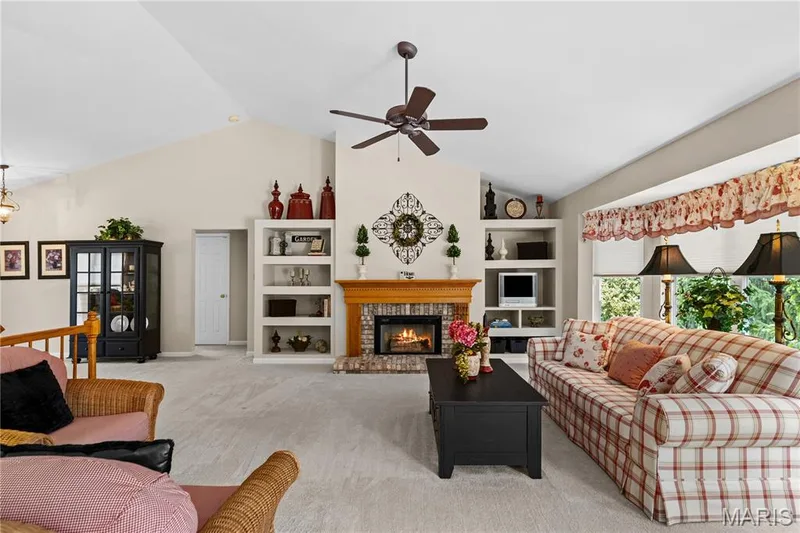 Same view of great room with fire in fireplace — 8 Autumn Grove Court, O'Fallon, MO 63366