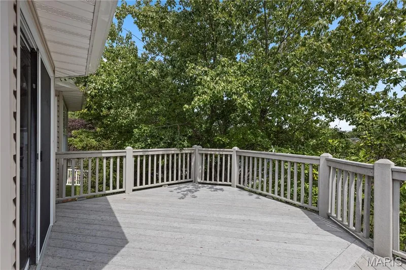 Another view of the tiered deck surrounded by trees for privacy — 8 Autumn Grove Court, O'Fallon, MO 63366