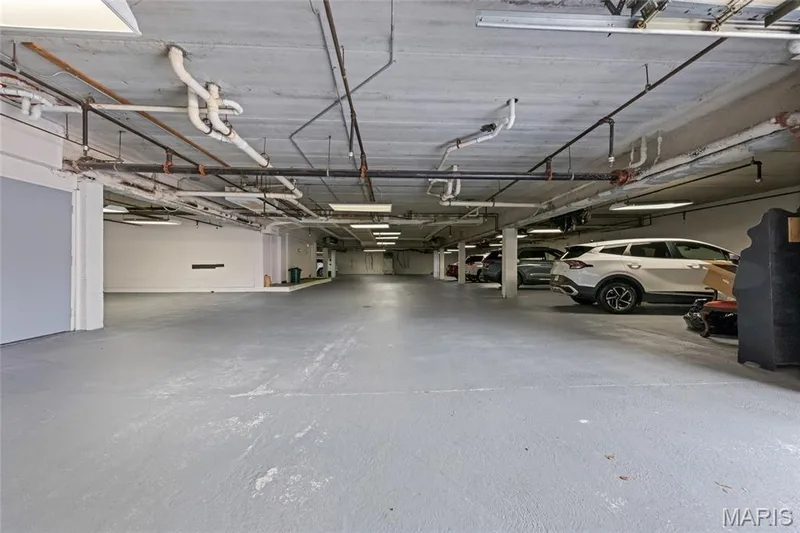 Two Assigned parking spots in garage with storage room next to parking spaces. — 1610 Lake Knoll Drive #1N, Lake St. Louis, MO 63367