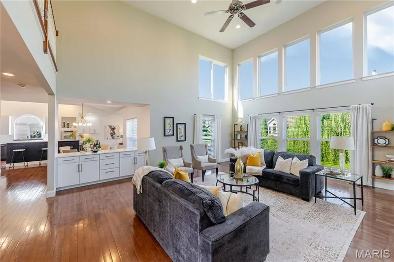 Open floor plan with great room with gas fireplace overlooking the kitchen and living area beyond — 11 Orchard Trace Lane, Wildwood, MO 63040