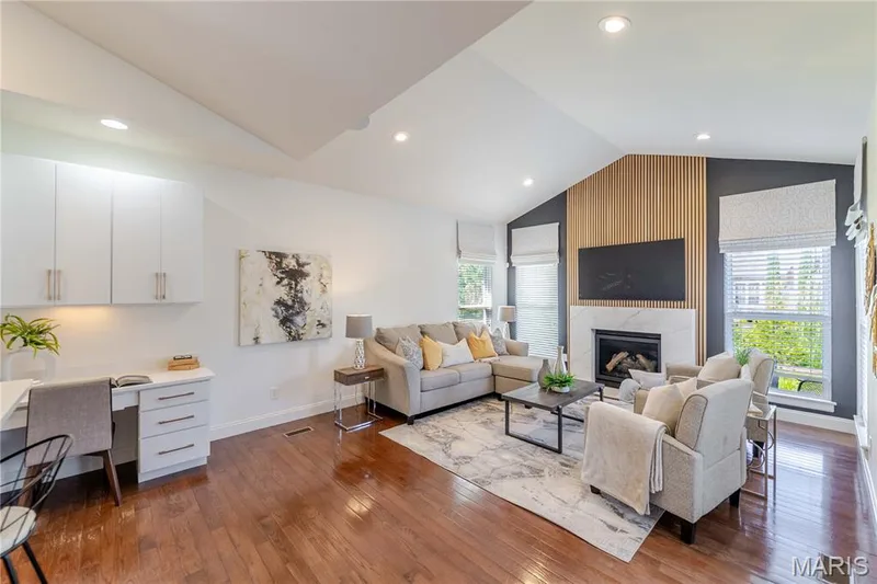 Recently renovated hearth room is open to the kitchen and has been updated with stunning accent wall and gas fireplace. Walks out onto the oversized patio. — 11 Orchard Trace Lane, Wildwood, MO 63040