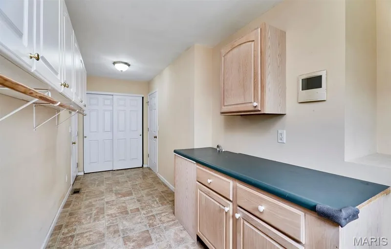 Extended laundry room with a lot of hanging and storage space — 1516 Hibernation Hollow, Wentzville, MO 63385