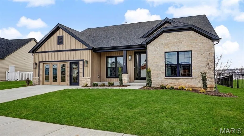 Contemporary ranch-style residence featuring a combination of light-colored brick and vertical panel siding — 312 Summer Glen Lane, St Charles, MO 63301