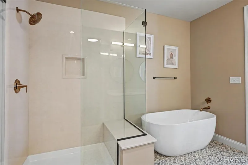 Freestanding soaking tub and glass-enclosed shower with bronze fixtures — 312 Summer Glen Lane, St Charles, MO 63301