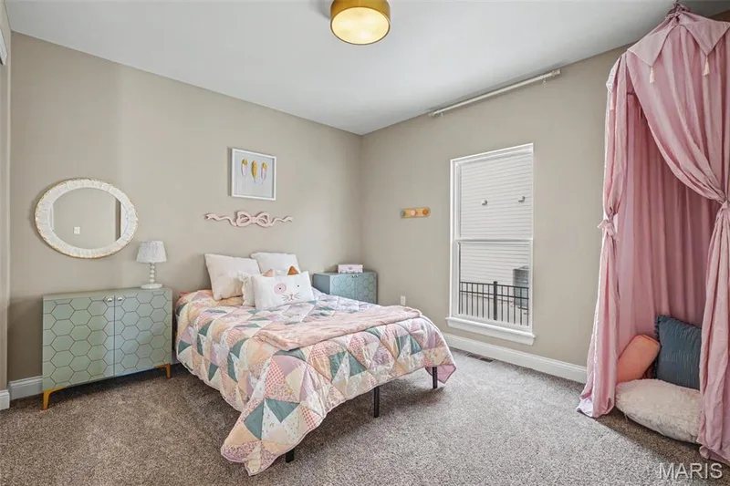 Carpeted room with a single window featuring blinds and exterior railing visible — 312 Summer Glen Lane, St Charles, MO 63301