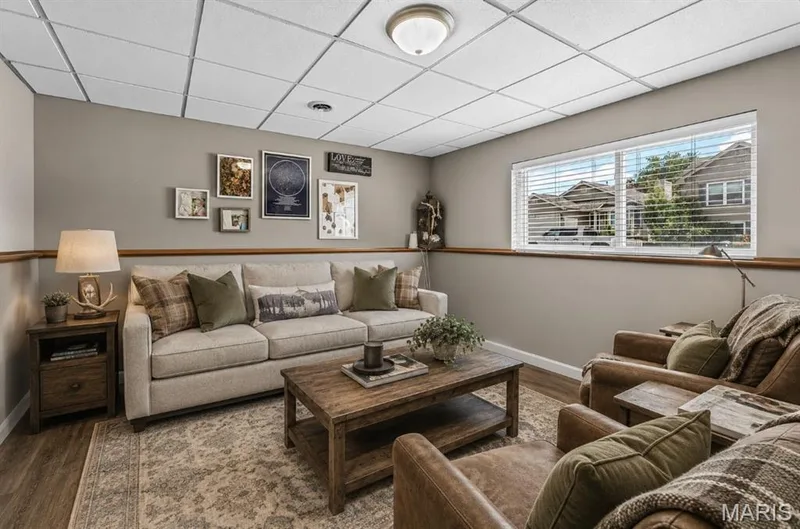 AI generated photo of the downstairs situated as bonus living room/den. — 171 Kunze Drive, St Charles, MO 63303