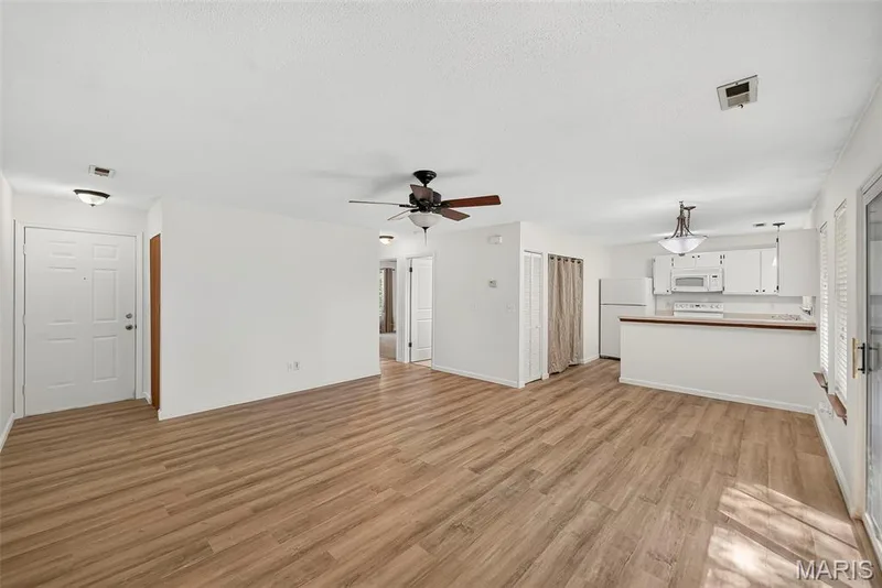 Open Floor Plan with Luxury Vinyl Plank Flooring in Main Living Areas — 1044 Sugar Creek Court #5, St Peters, MO 63376