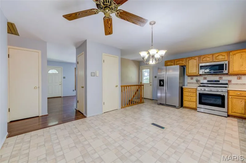 The kitchen has a pantry and an open staircase to the finished basement. — 3357 Glendale Avenue, St Charles, MO 63301
