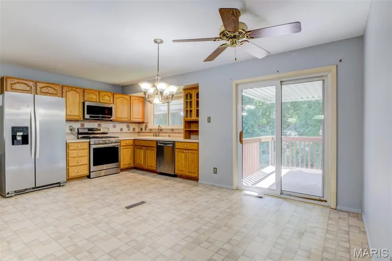 Large eat-in kitchen with a sliding door to the covered rear deck. — 3357 Glendale Avenue, St Charles, MO 63301