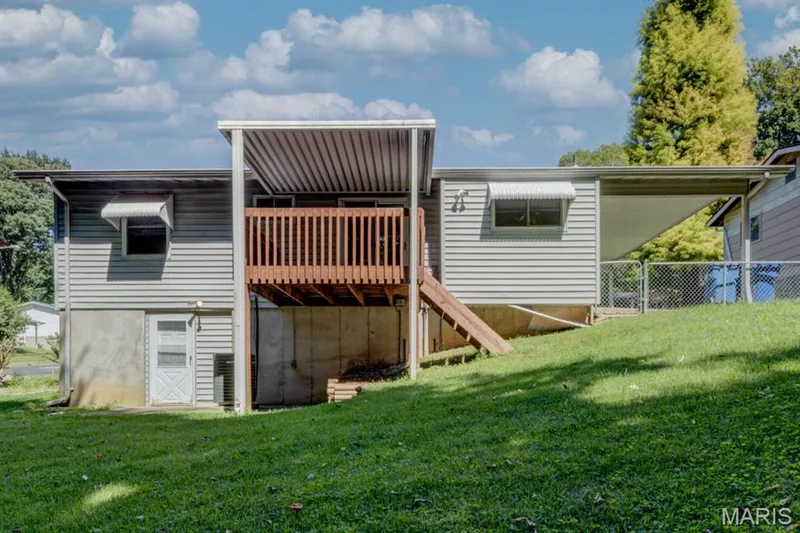The rear of the home showing the covered deck and the walk-out door. — 3357 Glendale Avenue, St Charles, MO 63301