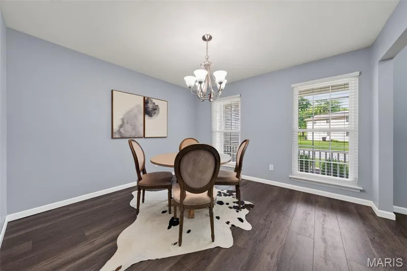 Dining area featuring LVP flooring and plenty of natural light. — 1016 Lafayette Place, Lake St. Louis, MO 63367