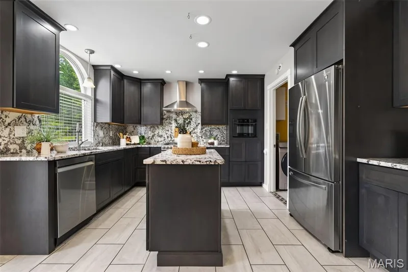 Kitchen features 42 in cabinets, granite countertops and backsplash, stainless steel appliances (Fridge stays!) and ceramic tile flooring. — 1016 Lafayette Place, Lake St. Louis, MO 63367