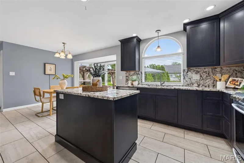 Kitchen features 42 in cabinets, granite countertops and backsplash, stainless steel appliances (Fridge stays!) and ceramic tile flooring. — 1016 Lafayette Place, Lake St. Louis, MO 63367
