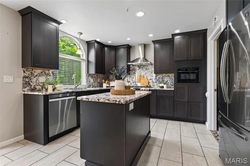 Kitchen features 42 in cabinets, granite countertops and backsplash, stainless steel appliances (Fridge stays!) and ceramic tile flooring. — 1016 Lafayette Place, Lake St. Louis, MO 63367