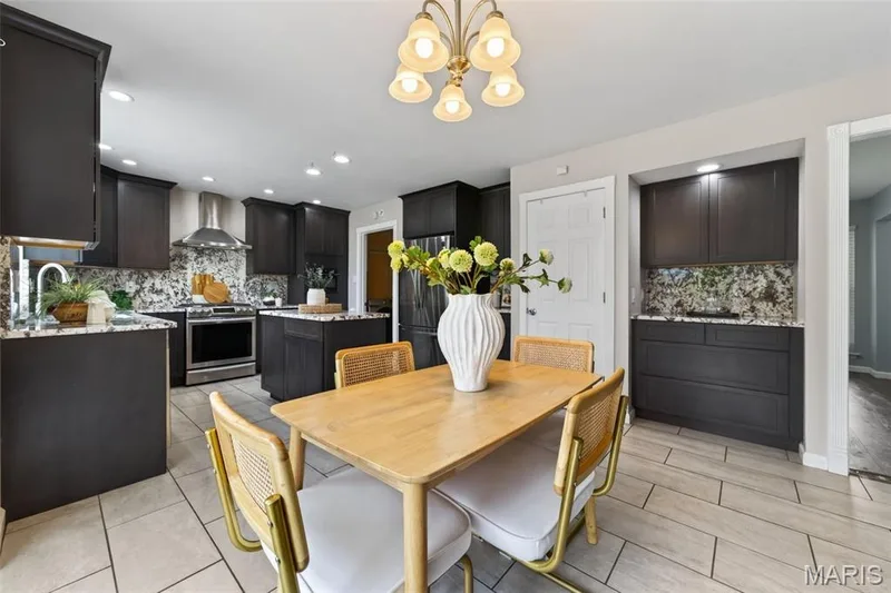 Kitchen features 42 in cabinets, granite countertops and backsplash, stainless steel appliances (Fridge stays!) and ceramic tile flooring. — 1016 Lafayette Place, Lake St. Louis, MO 63367
