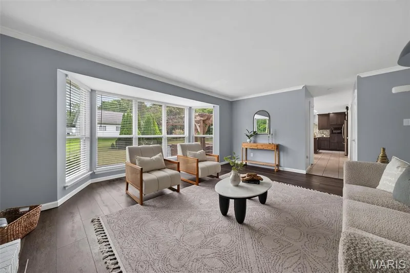 Bright and spacious living room with bay windows, crown molding and a gas fireplace. — 1016 Lafayette Place, Lake St. Louis, MO 63367